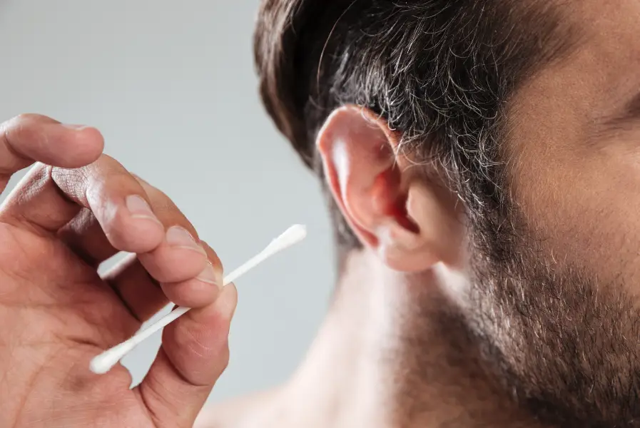 Men holding earbud